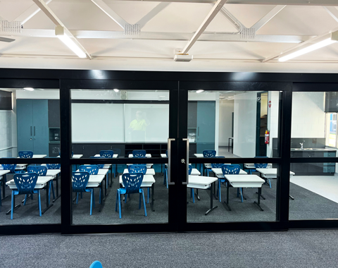 Glazed acoustic sliders installed in a flexible learning area in a school