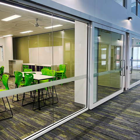 Griffin-Bi-parting-Sliders-with-Fixed-Glazing-+-Op-wall Bi-parting Sliders with Fixed Glazing and an acoustic operable wall installed in a school