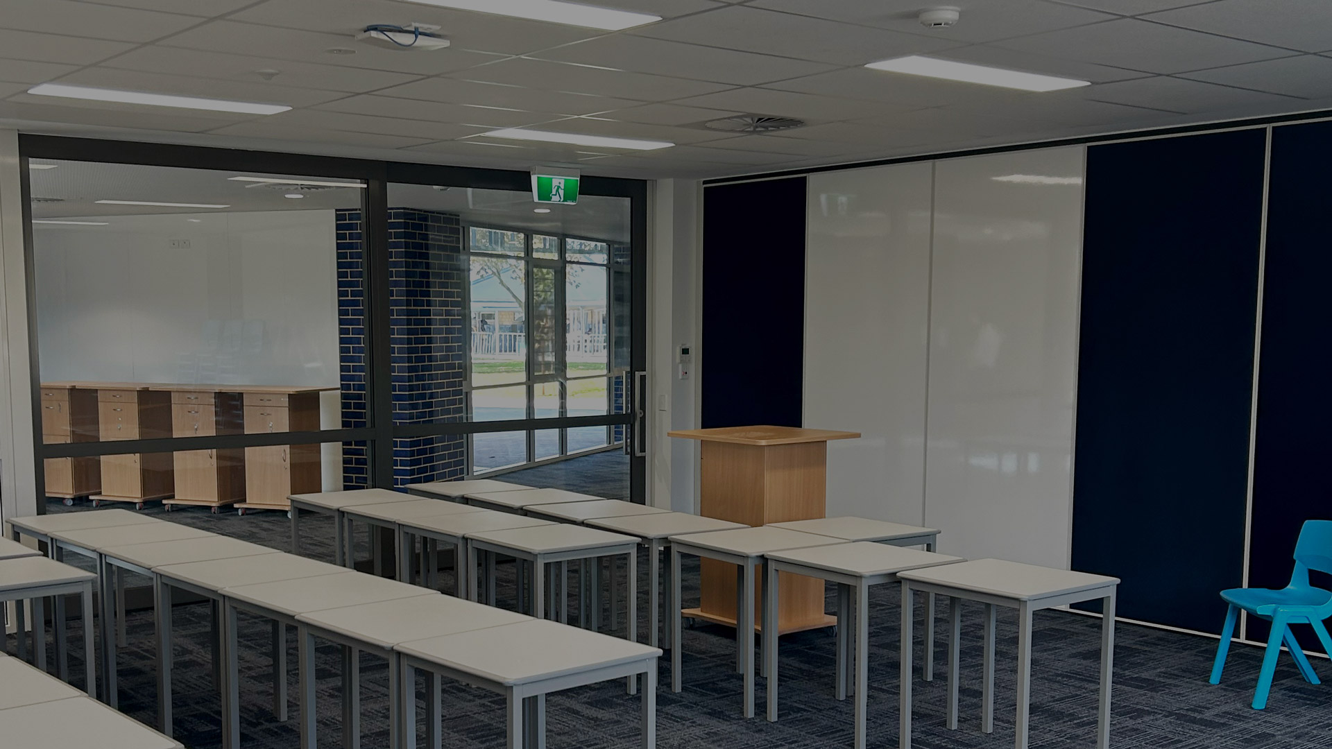 glazed acoustic slider and solid operable wall with whiteboards installed in a school