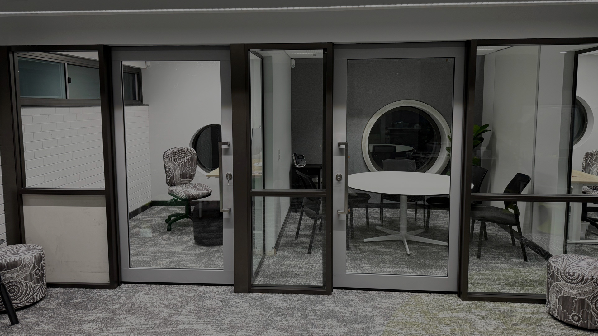 Glazed recess mounted single clear view acoustic sliders installed in a school